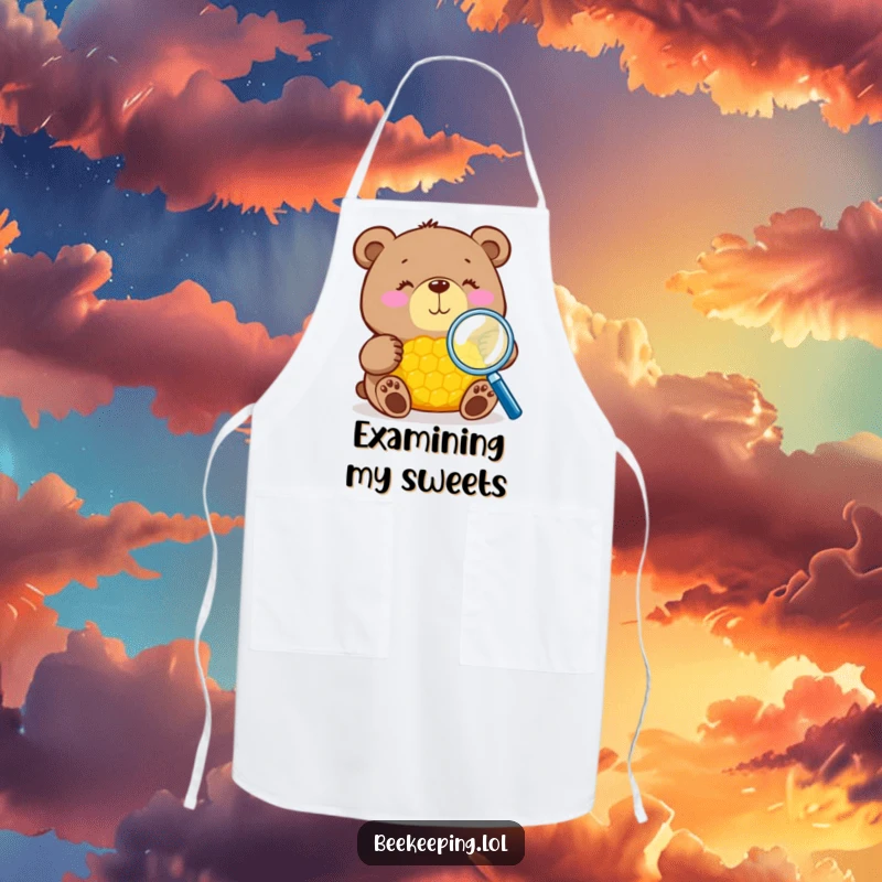 Funny bear with magnifying glass inspecting honeycomb on a kitchen apron, practical and amusing, great gift.