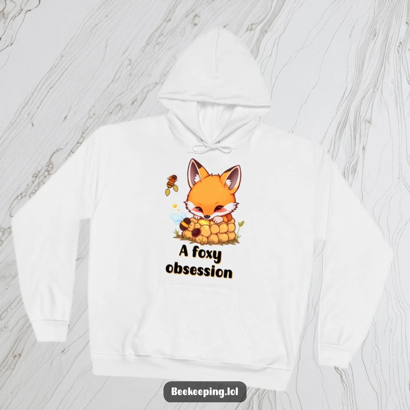 Funny hoodie featuring a fox curiously investigating a bubbling beehive with interest.