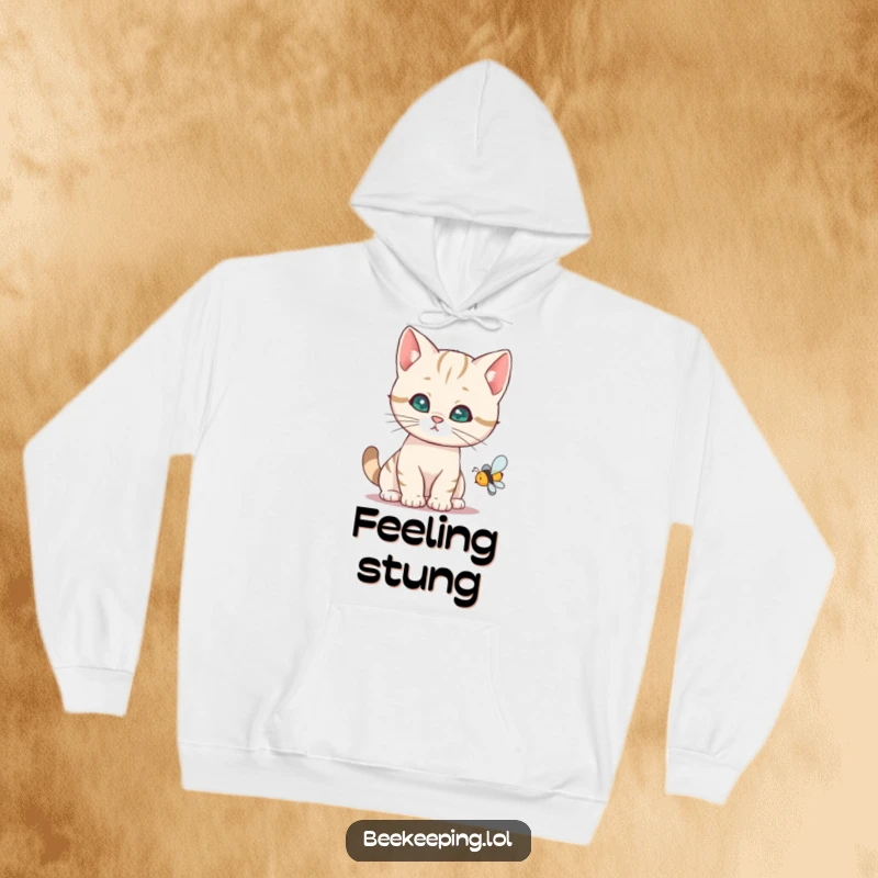 Funny cat hoodie illustrating a curious cat focused on a buzzing bee, a warm and humorous design.