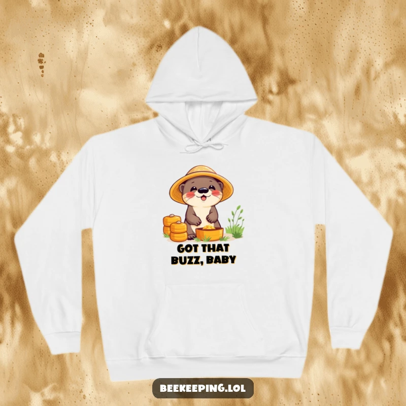 Funny hoodie with a giggling otter in a straw hat, diligently working at beehives, offering a warm and humorous visual.