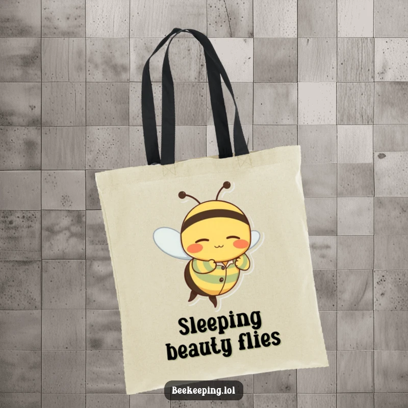 Funny tote bag with a wobbly bee character in striped pajamas flying with a contented, sleepy grin.